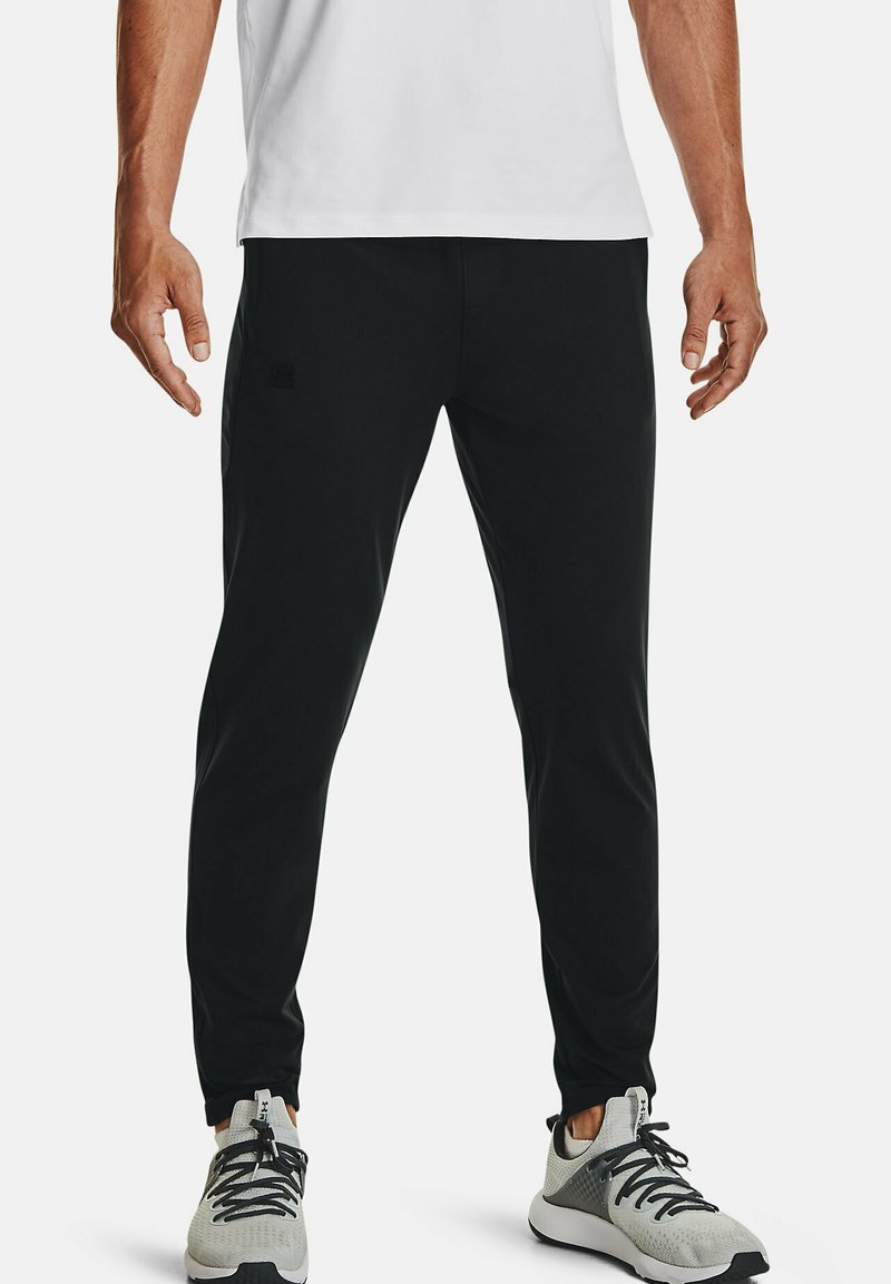 Under Armour Tracksuit bottoms black/black Zalando.co.uk
