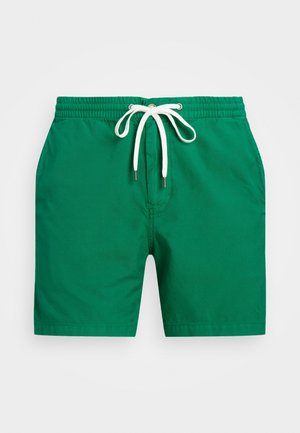 Shorts de bain verts en tissu texturé, avec une taille élastique, un cordon de serrage blanc et des bords ourlés. Pas de poches visibles.