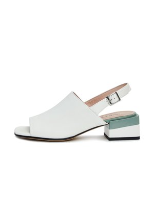 Witte leren open teen slingback schoen met een blokhak in wit en groen, en een zilveren gespsluiting.