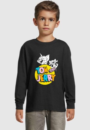 Schwarzes Langarm-T-Shirt mit einem großen Grafikmotiv von Tom und Jerry. Text "TOM und JERRY" in leuchtenden Farben auf einem gelben Kreis. Aus Baumwollmaterial.