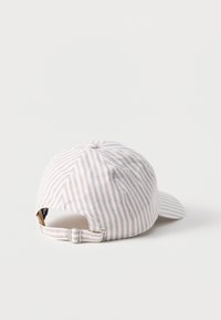 Καπέλο μπέιζμπολ με λευκές και μπεζ ρίγες, με ρυθμιζόμενο λουράκι με μεταλλική πόρπη, εμφανιζόμενο από πίσω σε λευκή επιφάνεια.