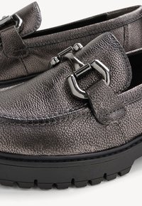 Metallic gray loafers with textured leather, featuring a wide strap and silver hardware detail, and a durable black rubber sole.