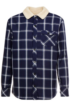 Navy plaid shirt with white and light blue lines; features a cream faux fur collar and a chest pocket with a black button.