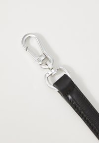 Black leather strap with silver metal hardware, featuring a swivel snap hook and a rounded ring attachment, smooth texture, and stitched detail.