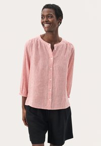 Red and white striped button-up shirt with a round neckline and 3/4 sleeves, paired with black shorts. Lightweight fabric, relaxed fit.