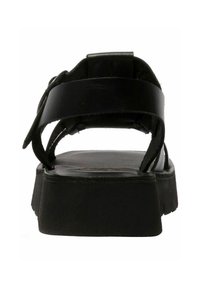 Czarne skórzane sandały z płaską podeszwą, regulowanymi paskami i wyściełanym wnętrzem. Projekt jest minimalistyczny i z otwartym tyłem.