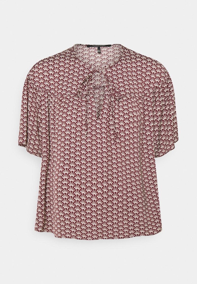 Red patterned blouse with short sleeves, featuring a tie detail at the neckline and a floral design in cream. Soft, lightweight fabric.