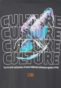 Black t-shirt with white text repeating "CULTURE" and a colorful abstract graphic. Includes orange text "CLTRE" at the bottom. Soft cotton material.