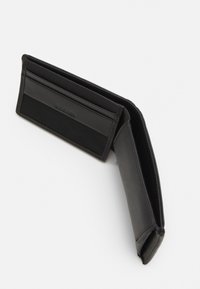 Black leather wallet with card slots and a textured panel, featuring a minimalist design and single-fold construction.
