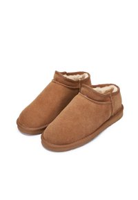 Zoccoli in suede marrone slip-on con morbida fodera in pelliccia sintetica, punta rotonda, altezza bassa alla caviglia e suola in gomma resistente per una buona aderenza.