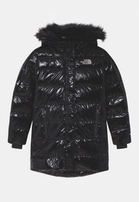 Black puffer jacket with a shiny, quilted design, featuring a fur-lined hood, side zippers, and logo accents on the chest.