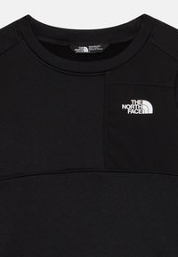 Sweatshirt noir au toucher doux, avec un décolleté arrondi et un logo blanc en haut à gauche. Conçu pour le confort et les activités sportives.