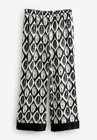 Pantaloni cu model alb-negru, cu un design în diamante ce include mâini și inimi. Brâu elastic, picioare largi și manșete negre la margine.