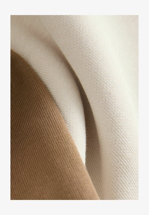 Kokvilnas audums bēšā un gaiši brūnā krāsā, gluda tekstūra ar nelielu ribojumu. Krāsas pārklājas, demonstrējot smalkas toņu variācijas.