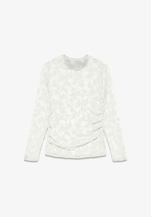 Valge pikkade varrukatega särk, millel on lillemuster ja külgedel kogutud tekstuur. Ümar kaelus ning pehme, kerge kangas.