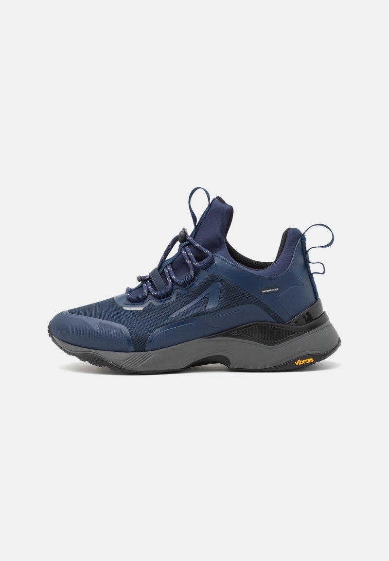 Navy blue waterproof sneakers with a textured upper, smooth accents, elastic laces, and a gripped vibram sole for traction.