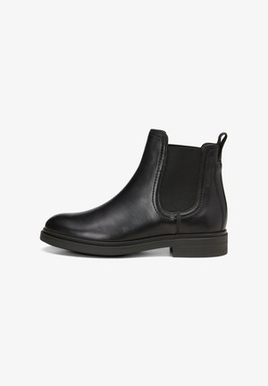 Black leather Chelsea boot with elastic sides, rounded toe, low stacked heel, and textured accents. Flat sole for stability.