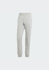 Pelēkas jogger bikses, kas izgatavotas no mīksta auduma, ar elastīgu jostasvietu, sānu kabatām un ribotām piedurknēm. Logo detaļa apakšējā kreisajā kājā.
