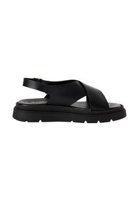Sandală neagră cu o talpă groasă, texturată. Are bretele încrucișate și o bretea la călcâi. Fabricată dintr-un material neted și flexibil.