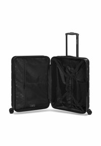 Black rolling suitcase with a hard shell, dual compartments, zippered mesh pocket, and cross straps for contents. Smooth, durable texture.