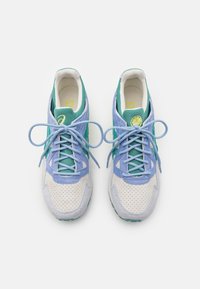 Sneakers med en flerfärgad design; har en ljusblå och grön mockaöverkonstruktion, perforerad vit lädertå och strukturerad gummisula.