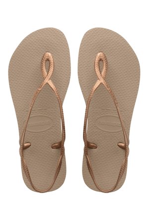 Brune gummiflip-flops med teksturerede såler, der har snoede, metalisk bronze stropper og et minimalistisk design. Størrelser 37-38 angivet.