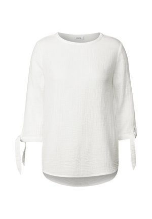 Witte blouse met driekwart mouwen, gestructureerde stof en gestrikte manchetten. Rondom afgeronde zoom en zachte, lichte materiaal. Merkje: CECIL.