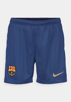 Siniset urheilushortsit, joissa on verkkomateriaali, brodeerattu FC Barcelonan logo ja kultainen Nike-logomerkki alareunassa oikealla puolella.