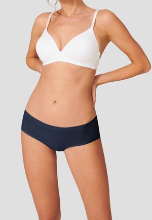 White soft cup bra with adjustable straps paired with navy blue hipster briefs. Both feature a seamless design and stretchy fabric.