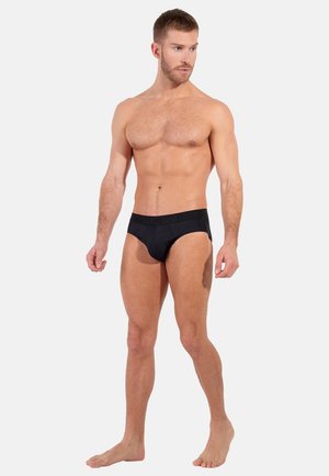 Zwarte herenboxershorts van een soepele stof, met een logo tailleband en een strakke pasvorm, die een solide, gestroomlijnd ontwerp tonen.