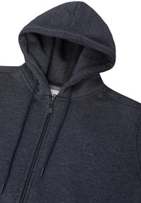 Felpa con zip di colore blu navy realizzata in tessuto morbido, con cappuccio regolabile con cordino, una piccola toppa con logo e una zip liscia.