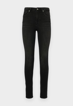Jeans noirs skinny en denim. Design classique à cinq poches avec fermeture éclair et bouton. Texture lisse et silhouette ajustée.