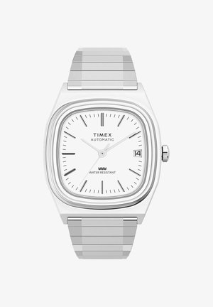 Montre automatique Timex argentée avec un cadran carré blanc, des marqueurs d'heure noirs, un affichage de la date à 3 heures et un bracelet en maillons métalliques.