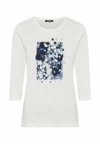Witte lange mouwen t-shirt met een blauw en wit abstract stippenpatroon aan de voorzijde, ronde halslijn en zachte katoen stof.
