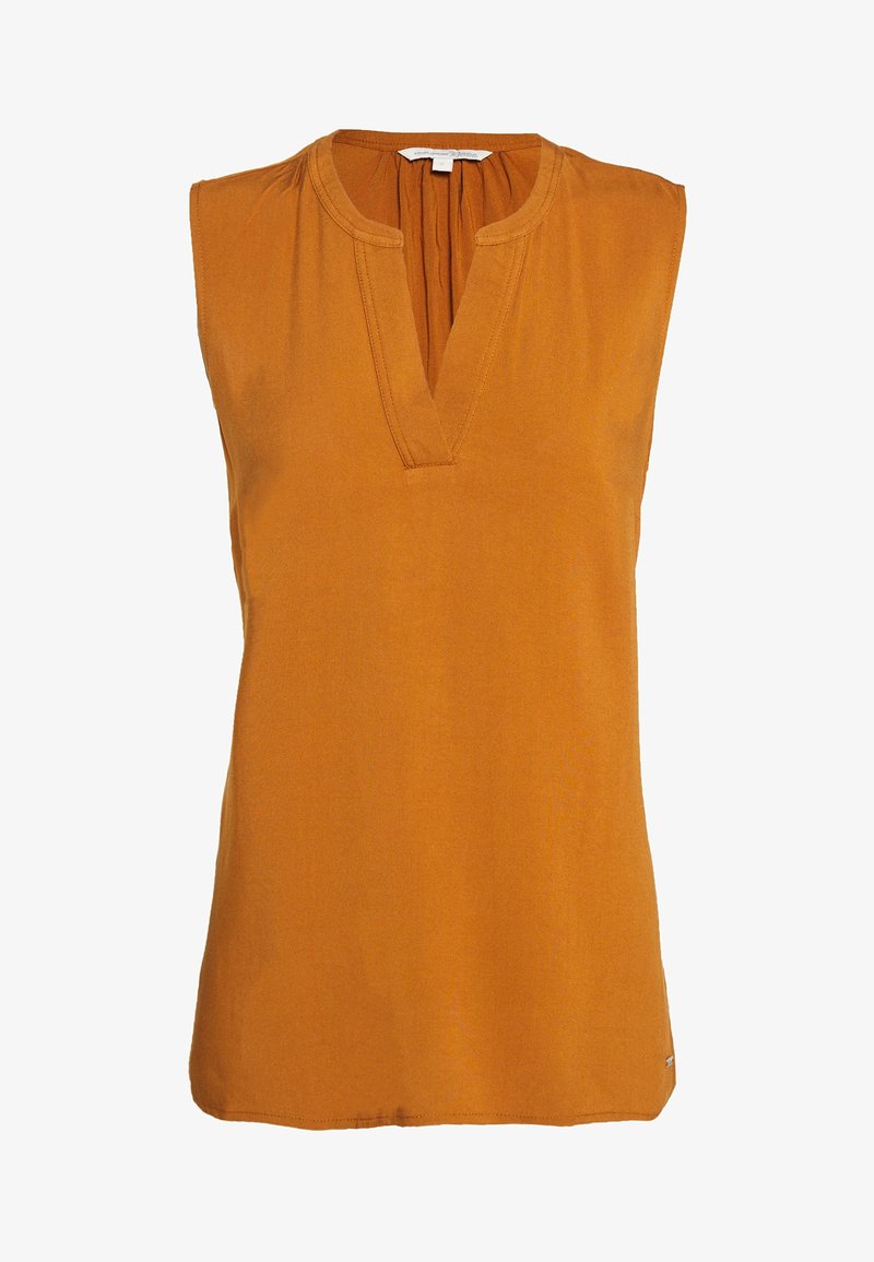 Blouse sans manches couleur orange brûlé avec un col en V fendu et des coutures discrètes, confectionnée dans un tissu léger.