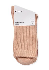Calze a coste beige realizzate in materiale morbido. Presentano un'etichetta con il nome del marchio 'Etam' e la taglia 'TU'. Texture liscia e lunghezza a metà polpaccio.