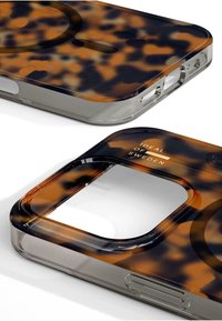 Tortoiseshell-patterned phone case with transparent edges, featuring cutouts for ports and the text "IDEAL OF SWEDEN" in gold lettering.