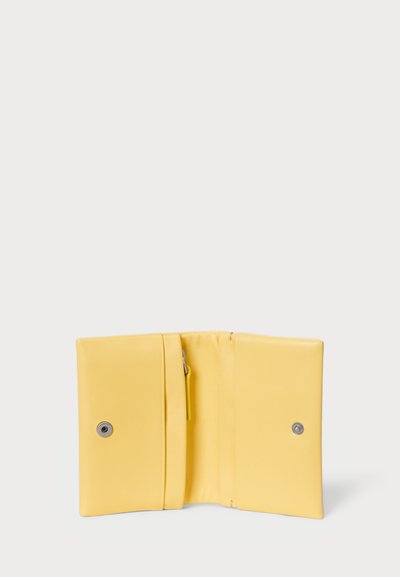 Yellow leather wallet with a smooth texture, featuring a zipper pocket and snap button closure. Opened to display interior compartments.