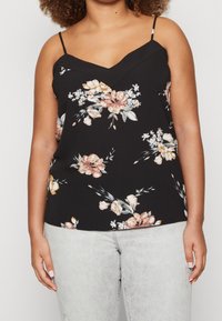 Svart ärmlös topp med V-hals, med ett blommigt mönster i mjuk rosa, krämfärgad och grön. Lättviktig tyg, justerbara band.