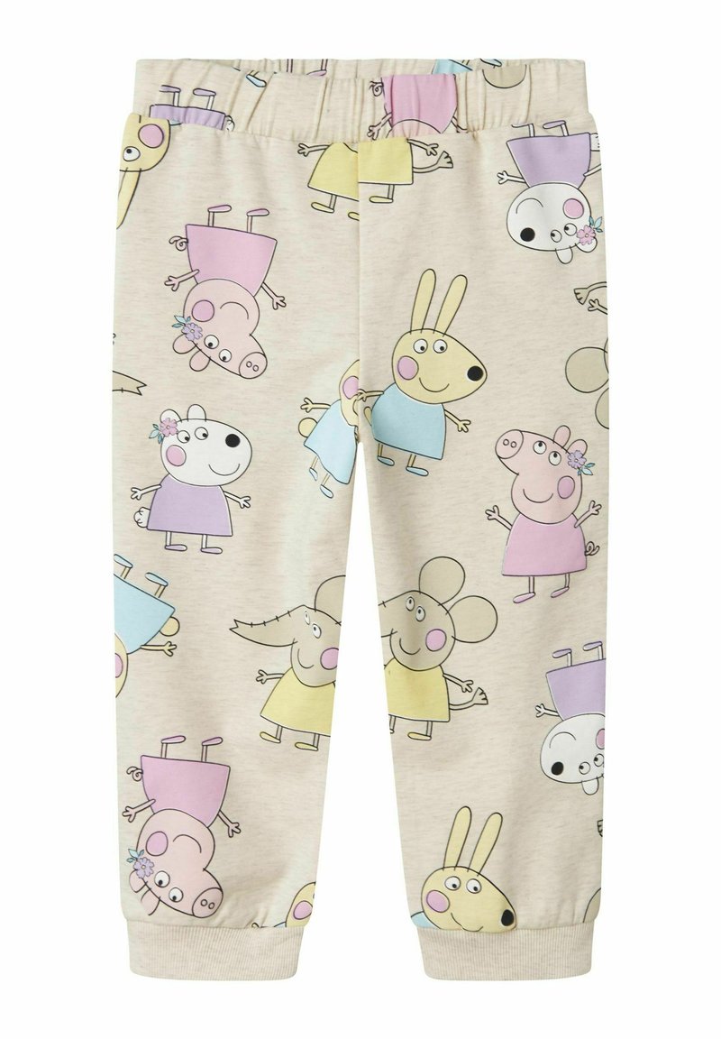 Helle beige joggebukser med fargerike tegneseriefigurer. Elastisk midjebånd og nedbrettede hem. Myk stoff med lekne mønstre.