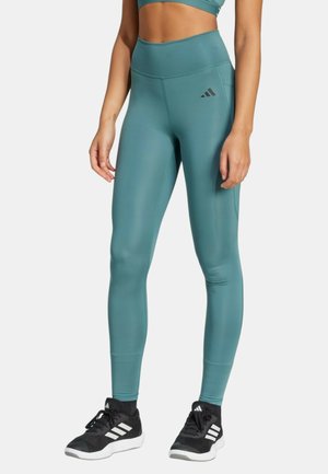 Leggings taille haute couleur sarcelle, en matière lisse et extensible, avec un détail logo sur le côté et une coupe élégante et ajustée.