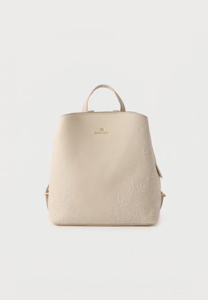 Sac à dos en cuir beige avec broderie florale délicate, poignée supérieure, bretelles réglables et logo doré « Anna Field » au centre avant.