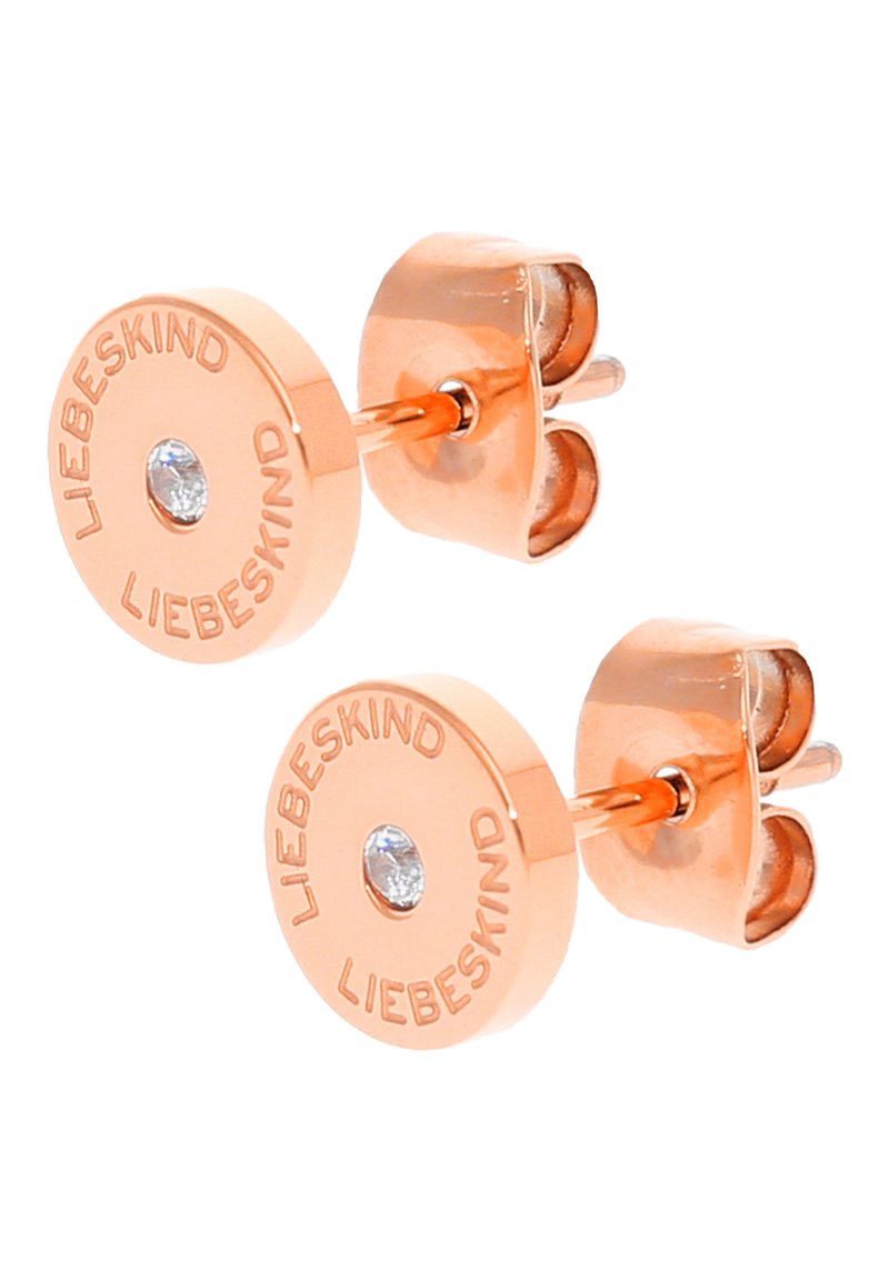 Roséguld studs som har en cirkulär design med ingraverad "LIEBESKIND"-text och en liten klar ädelsten i mitten.