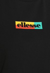 Černé bavlněné tričko s barevným logem "ellesse" v červené, žluté a tyrkysové barvě, umístěným na hrudníku. Hladká textura.