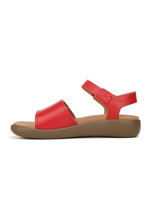 Red leather sandal with two wide straps, adjustable back strap, light brown cushioned sole, and textured detailing on straps.