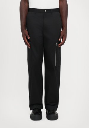 Black cargo pants with a loose fit, zipper pockets on the sides, made of durable fabric, featuring a straight leg design and standard waistband.