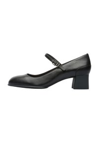 Black leather Mary Jane style shoe with a rounded toe, a single adjustable strap, and a short block heel. Smooth texture, minimal detailing.