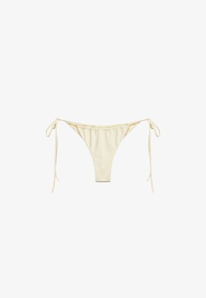 Bas de bikini couleur crème avec liens latéraux, en tissu lisse, présenté sur fond blanc.