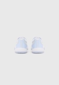 Light blue athletic shoes with a textured mesh upper, white sole, and minimal branding feature an open back design and perforations for breathability.