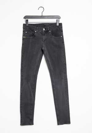 Black slim-fit jeans with front and back pockets, belt loops, and button closure hanging on a black hanger against a white background.